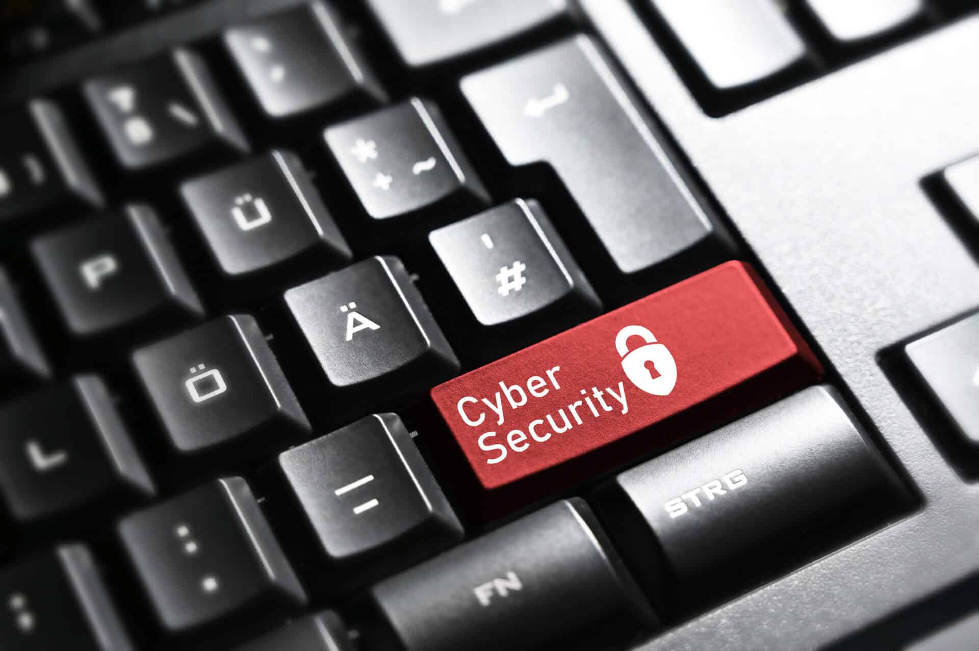 A red button on a keyboard that says cyber security